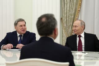 Russian president Vladimir Putin and his foreign policy adviser Yuri Ushakov attend talks in Moscow